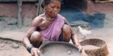 A Gadaba woman winnowing millet